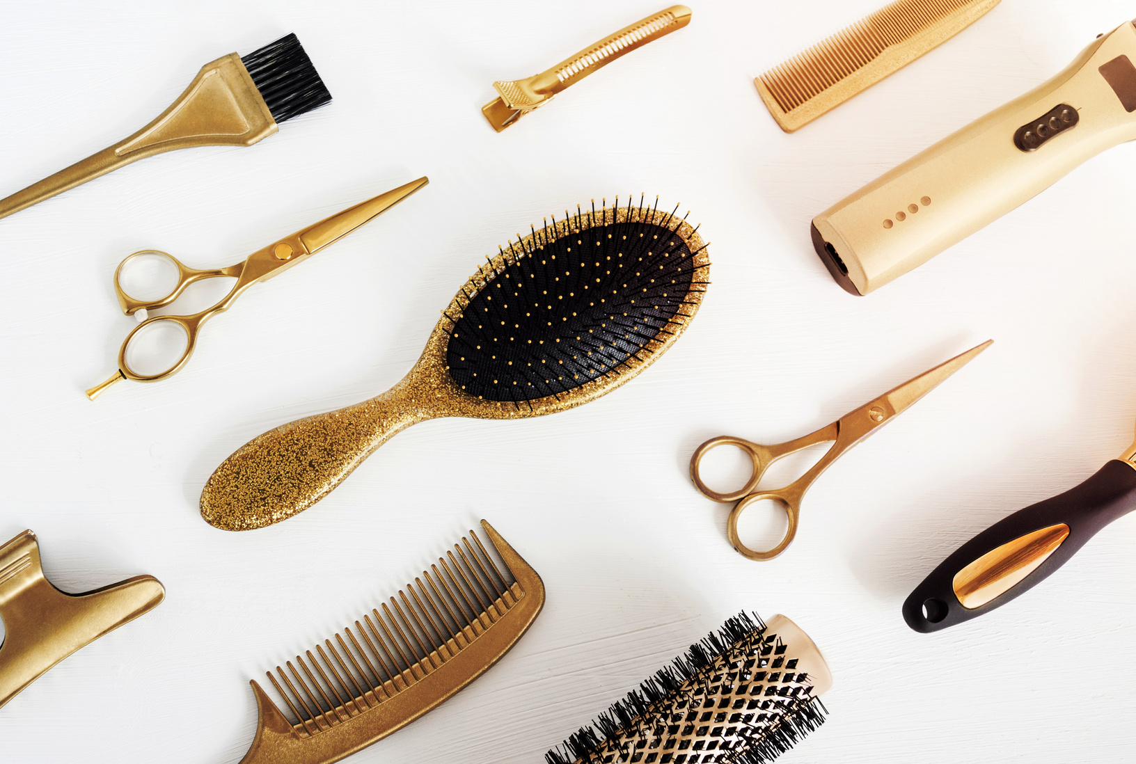 Background with golden hairdresser tools. Hair salon accessories